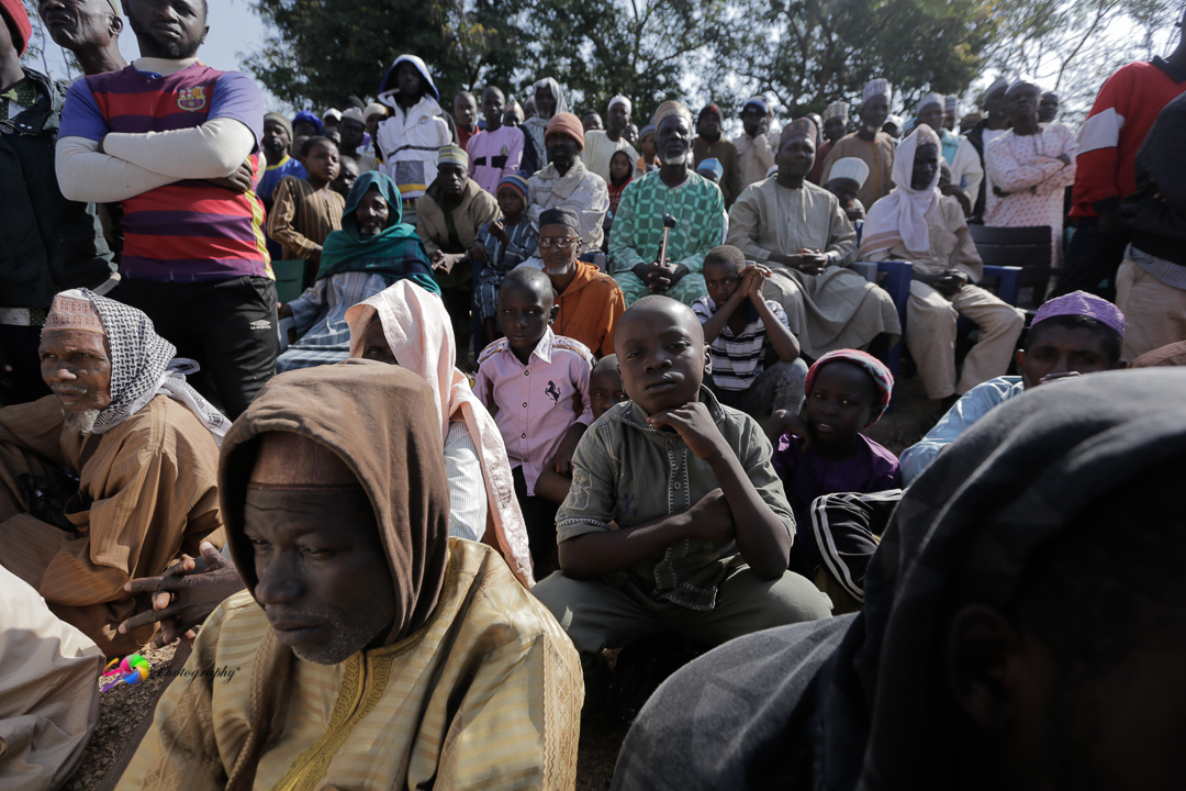 The community listening to the field team.